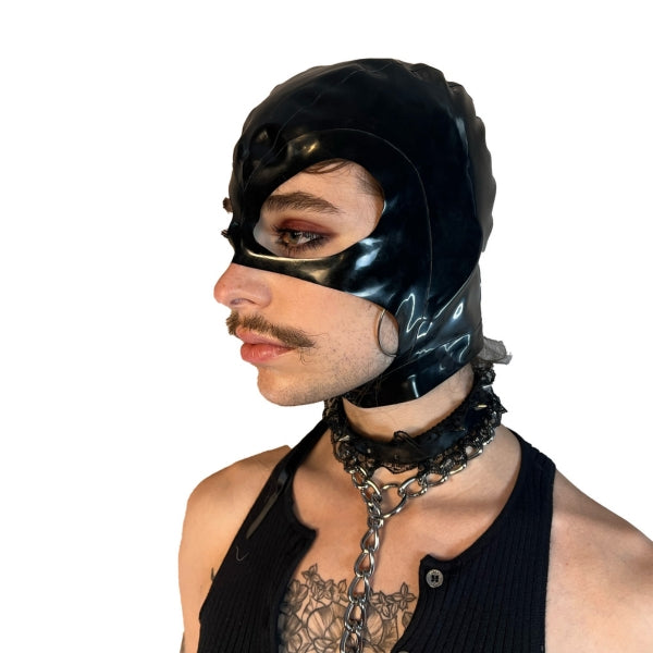 A model wearing black open mouth and eye basic latex hood, side view.