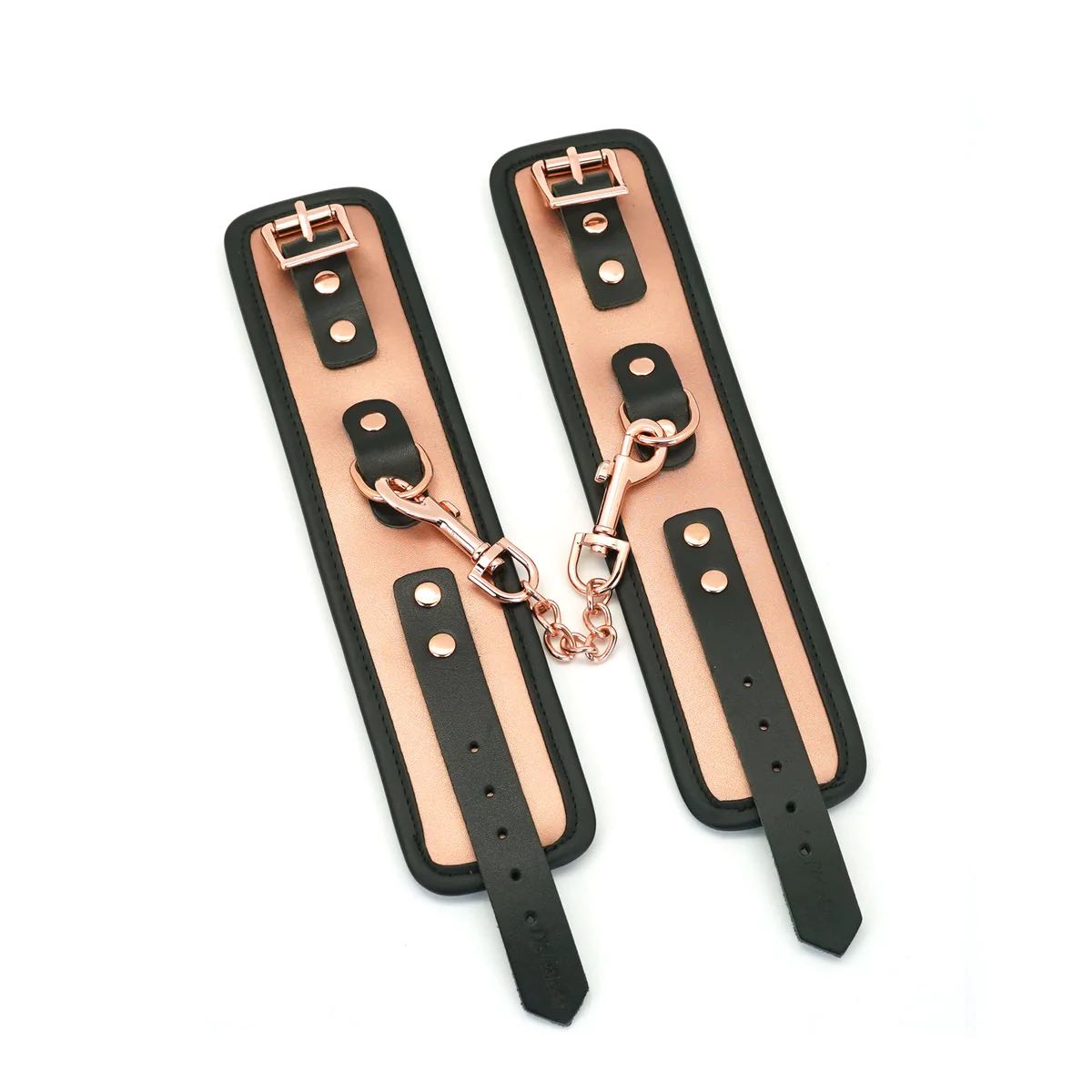 The Rose Gold Memory Leather Cuffs with Faux Fur LIning open and lying flat next to each other.
