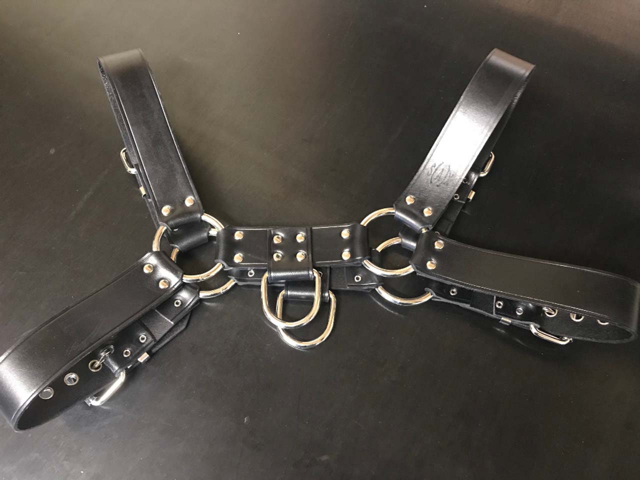 The Leather Bulldog Harness with D-Ring laying flat, rear view.