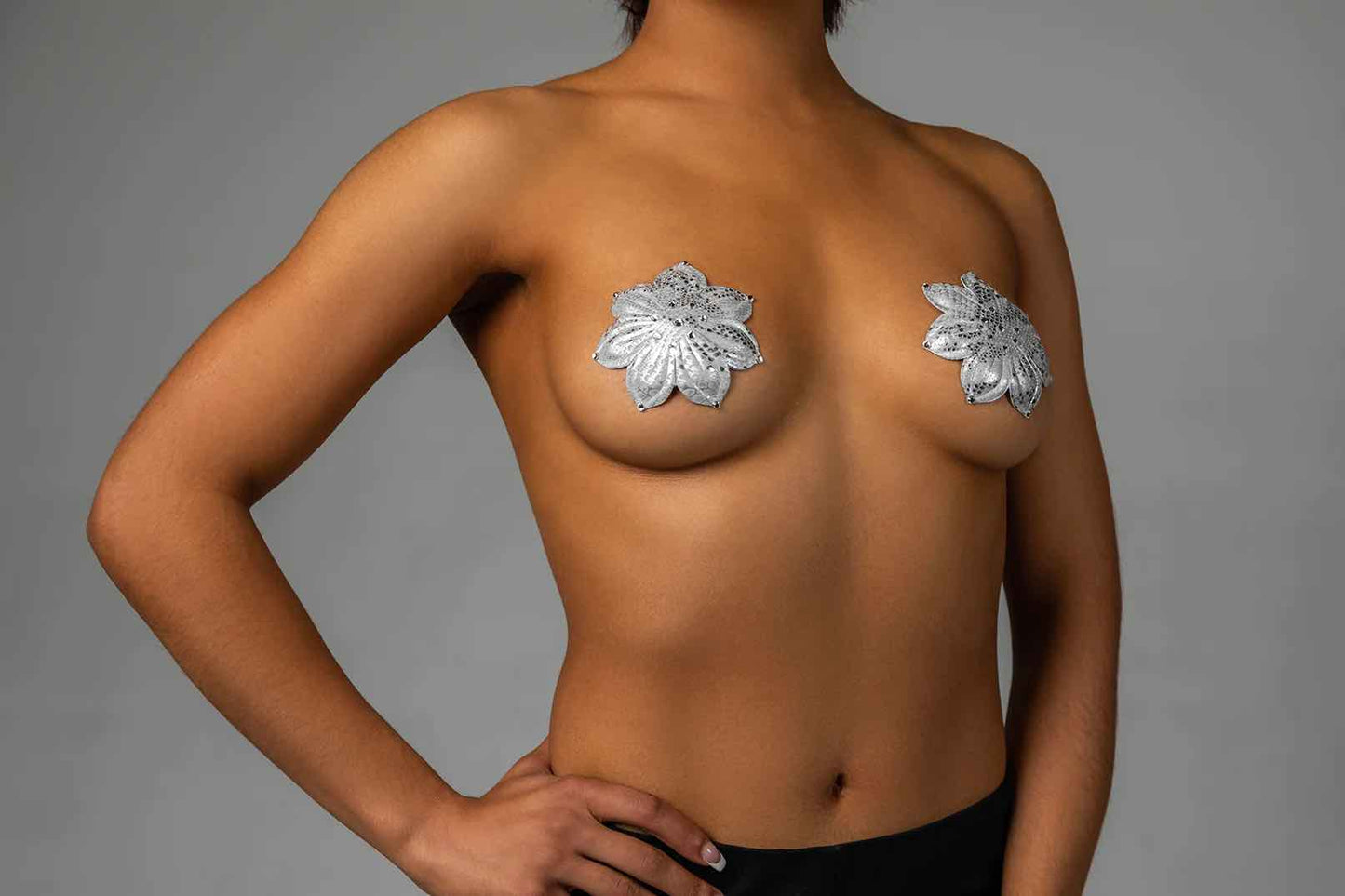 A model wearing the silver Athens Deluxe Reusable Pasties by Blissidy.