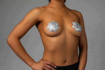 A model wearing the silver Athens Deluxe Reusable Pasties by Blissidy.