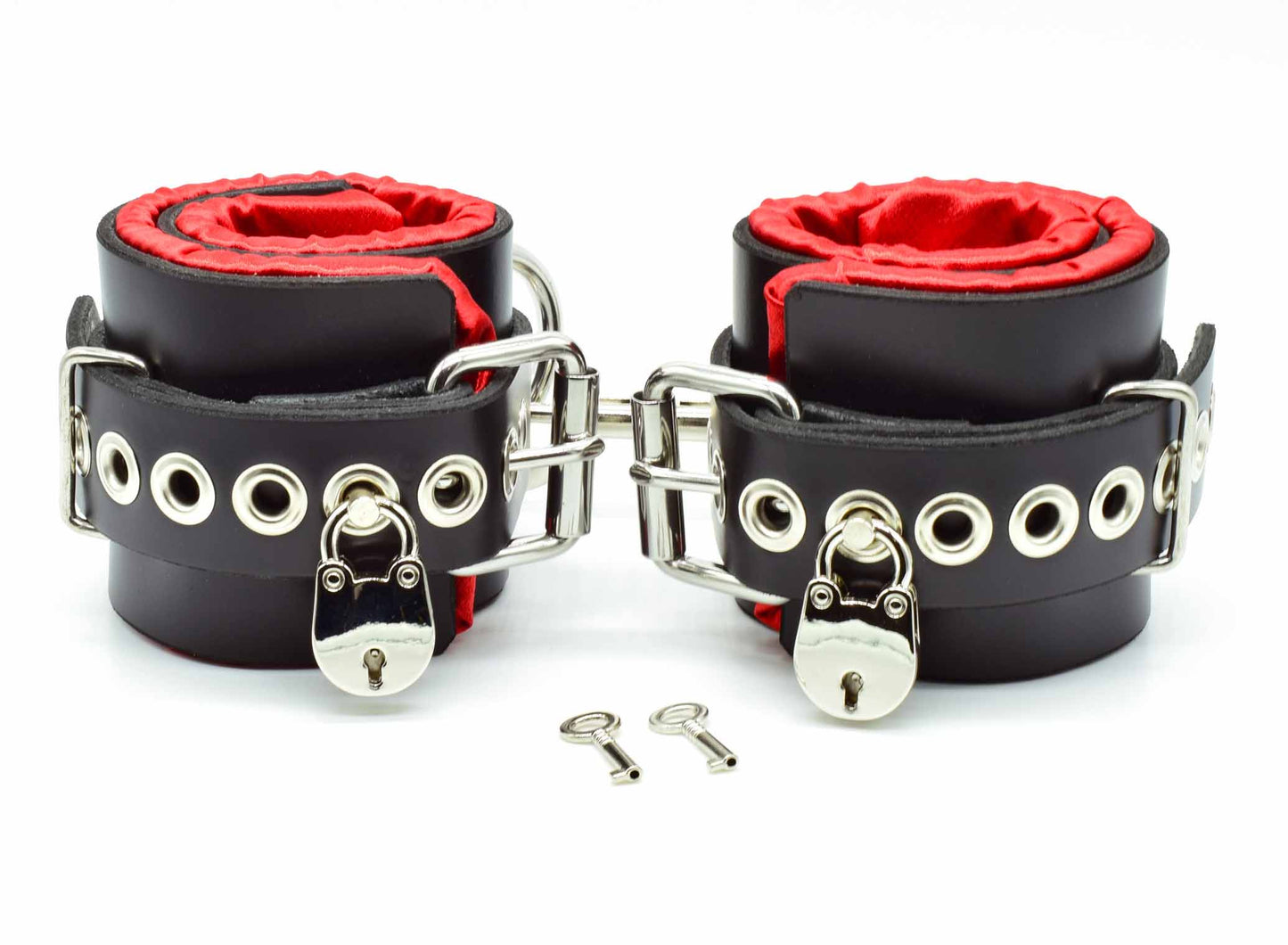Black with Red satin lined bondage cuffs with tentacle eyelets, locks on each cuff and keys.