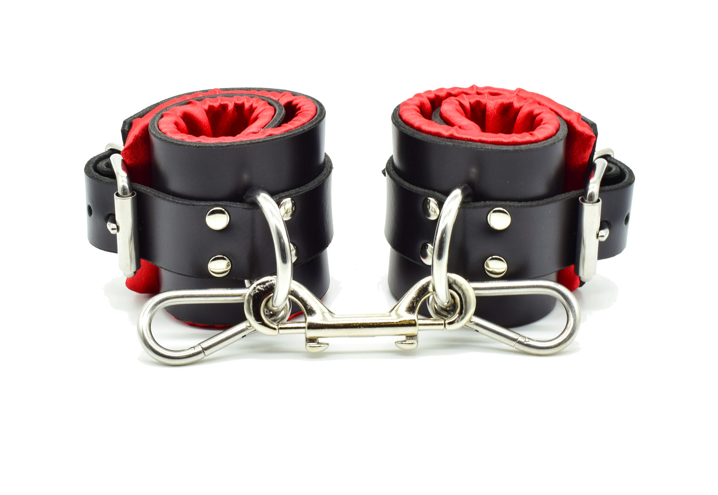 Red satin lined bondage cuffs with double snap clip connecting the cuffs.
