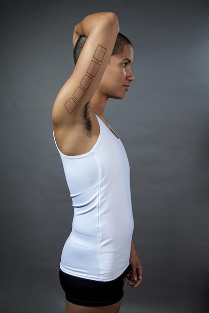 A model showing the side of the long Chest Binder untucked from pants.