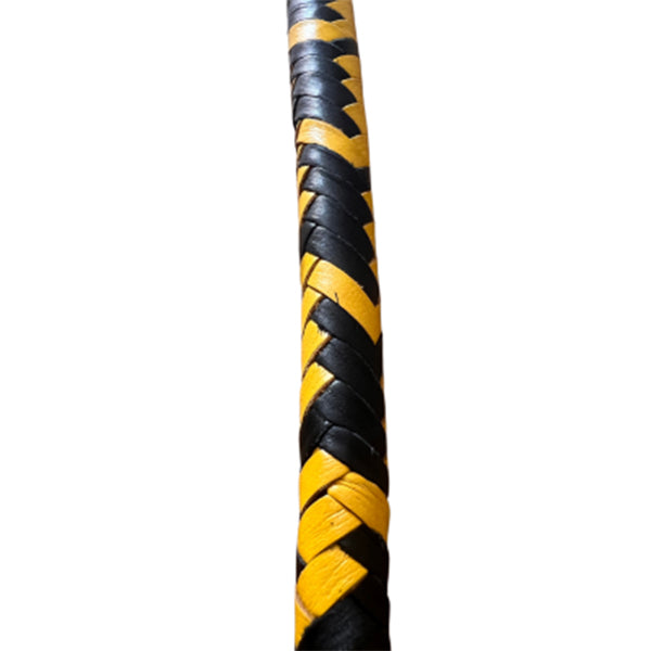 A close up of the body of yellow and black braided single tail whip.