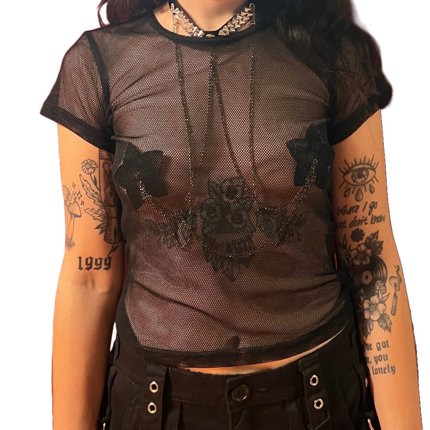 A model wearing Queen of the night reusable pasties with chains under a black fishnet shirt.