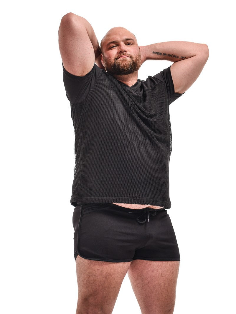 Fishnet Football Shirt front view with big ant tall model with arms up behind head