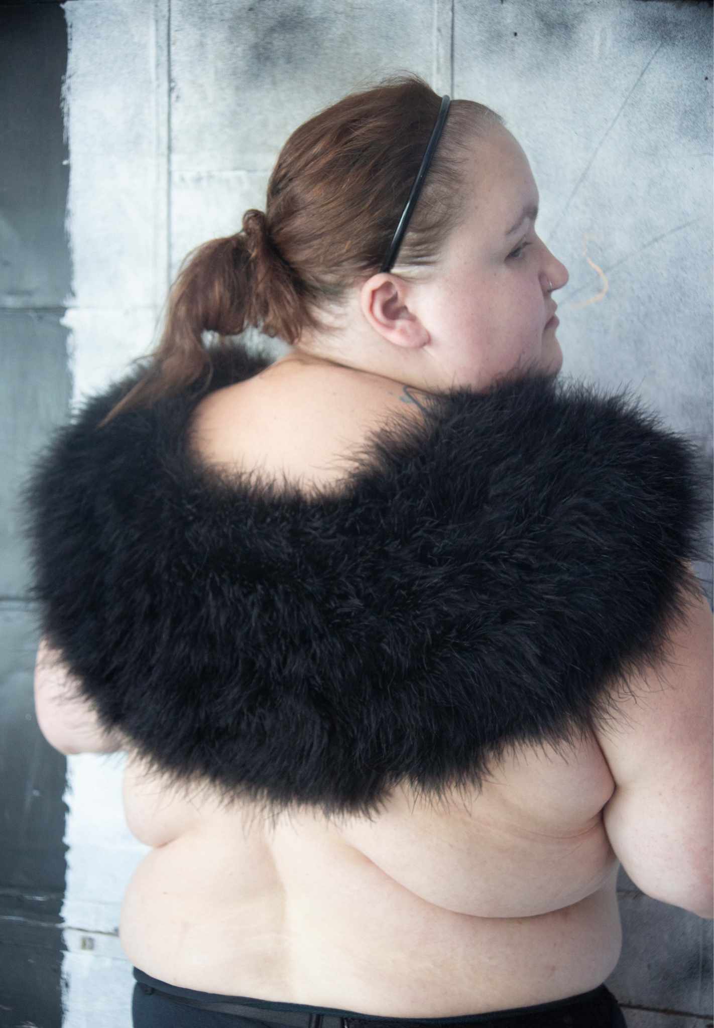 plus size model facing backwards wearing Marabou Capelet Black