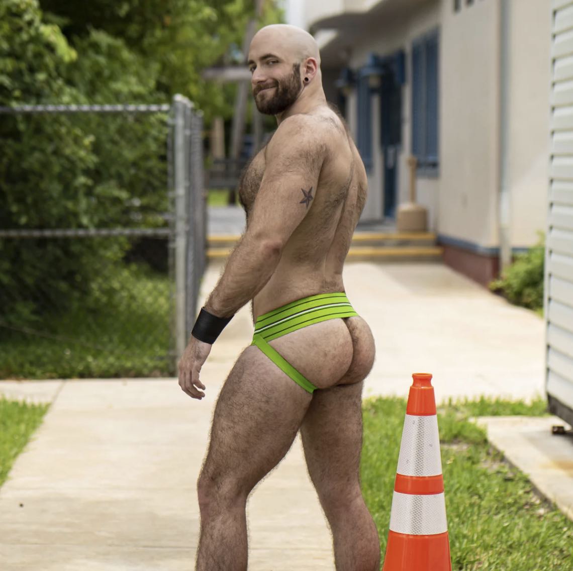 A model wearing the Nitro Green Gruff Pup UV Quarterback Jock, side view.