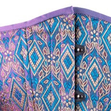 A closeup of the royal shimmer brocade corset fabric in blue, purple and gold.