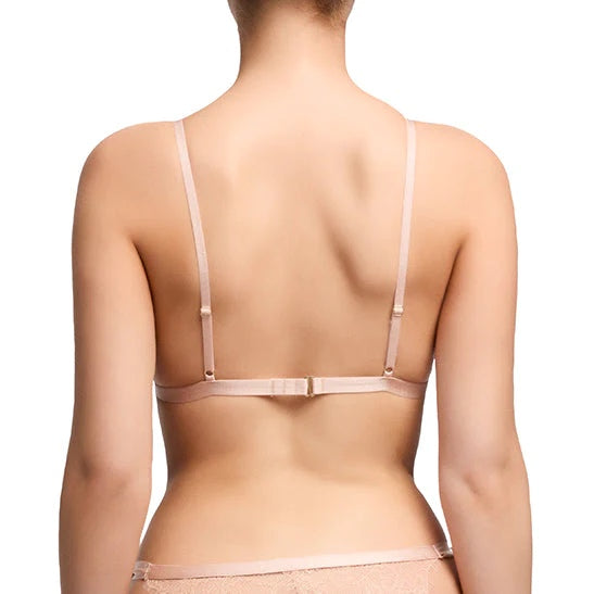 A model wearing the Fantacist Antique Peach Tie Front Glimmer Lace Bralette, rear view.