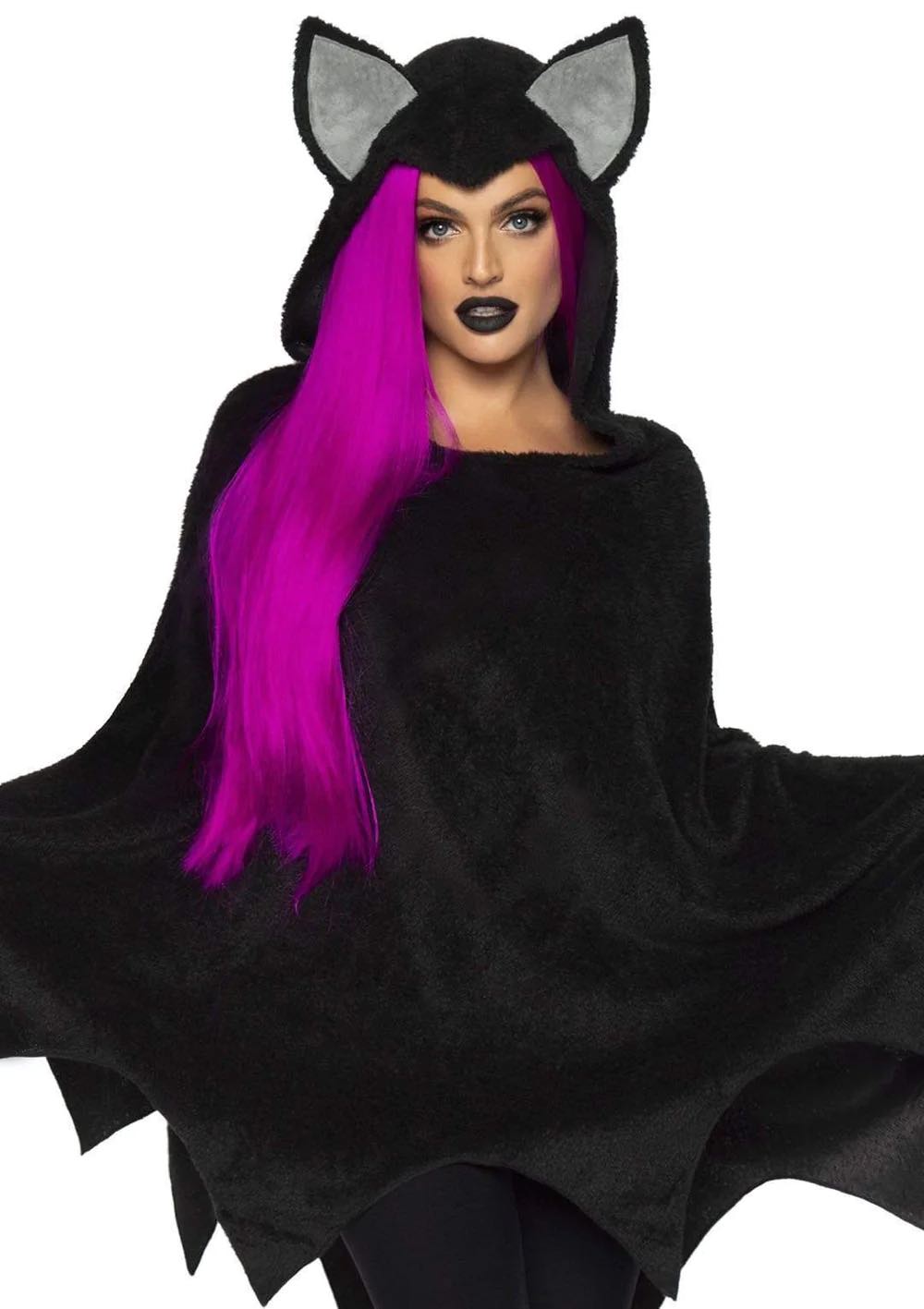 A mid length view of a model wearing the Bat Poncho over black leggings, front view.