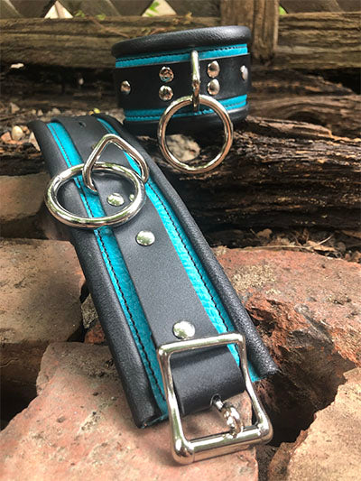 Teal rolled leather deluxe cuffs one closed, other stretched out.