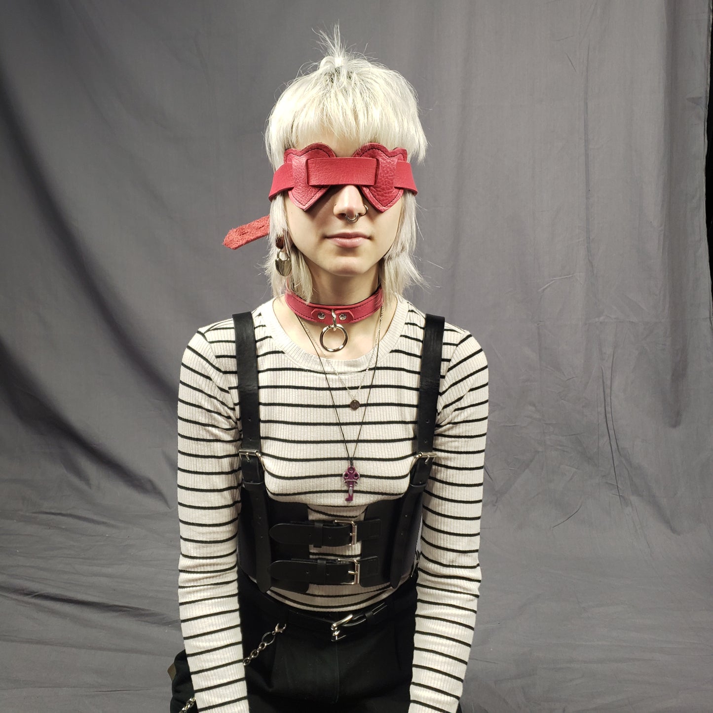 A model showing the buckle of the Red Leather Heart Eye Muffs.