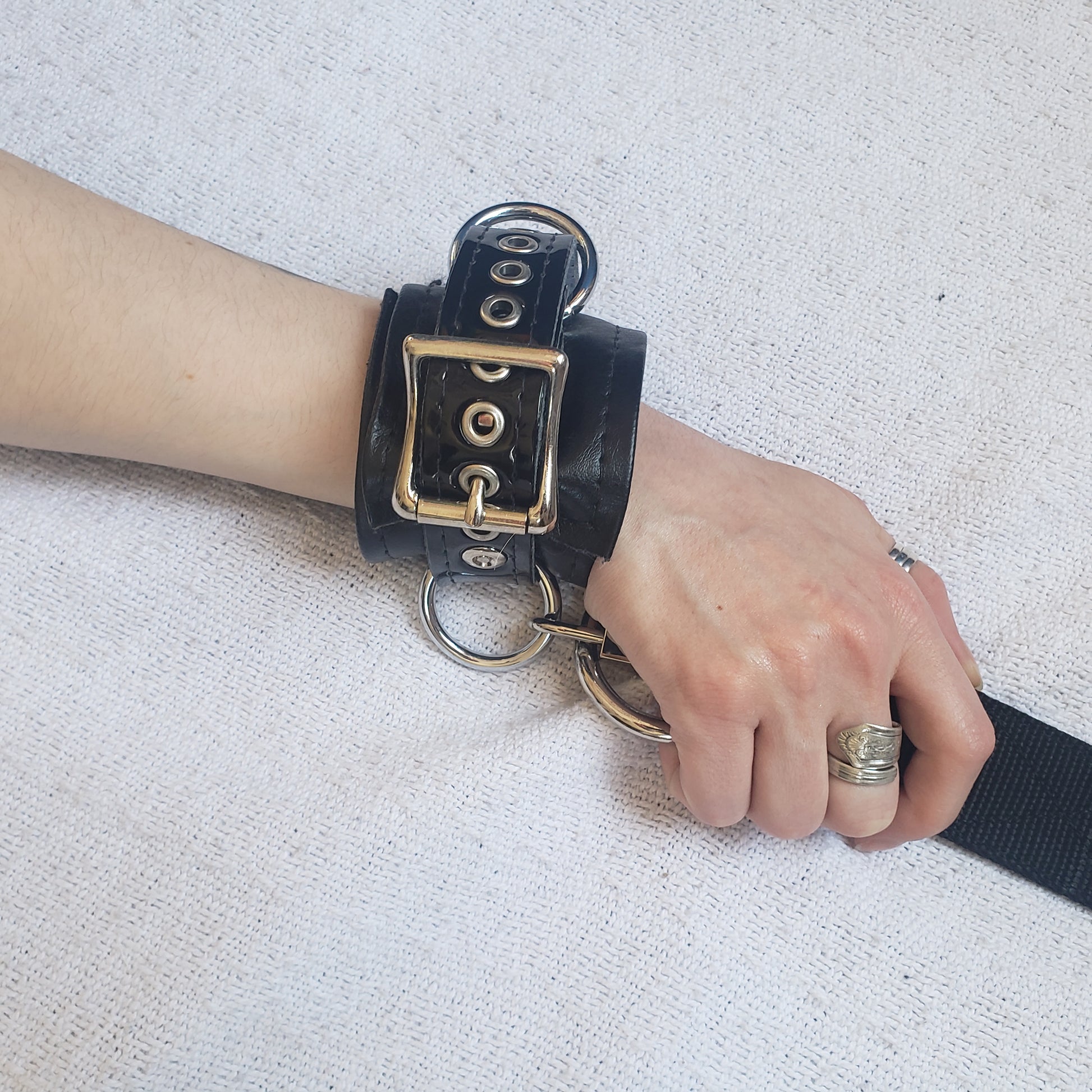 Wrist cuff with strap attached on model's hand.