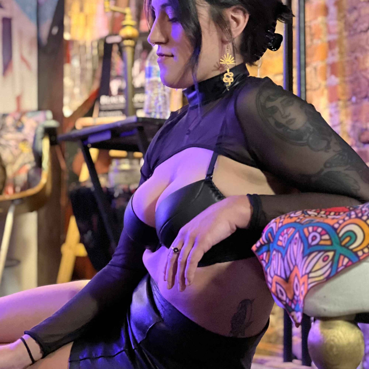 Model wearing Mesh Shrug with Wetlook Collar, highlighting front cut of Mesh Shrug