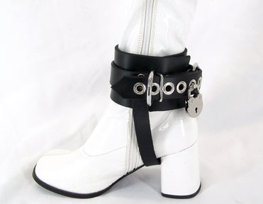 left side view of white patent boot with black shoe lock ankle cuff showing ankle strap closure with lock on