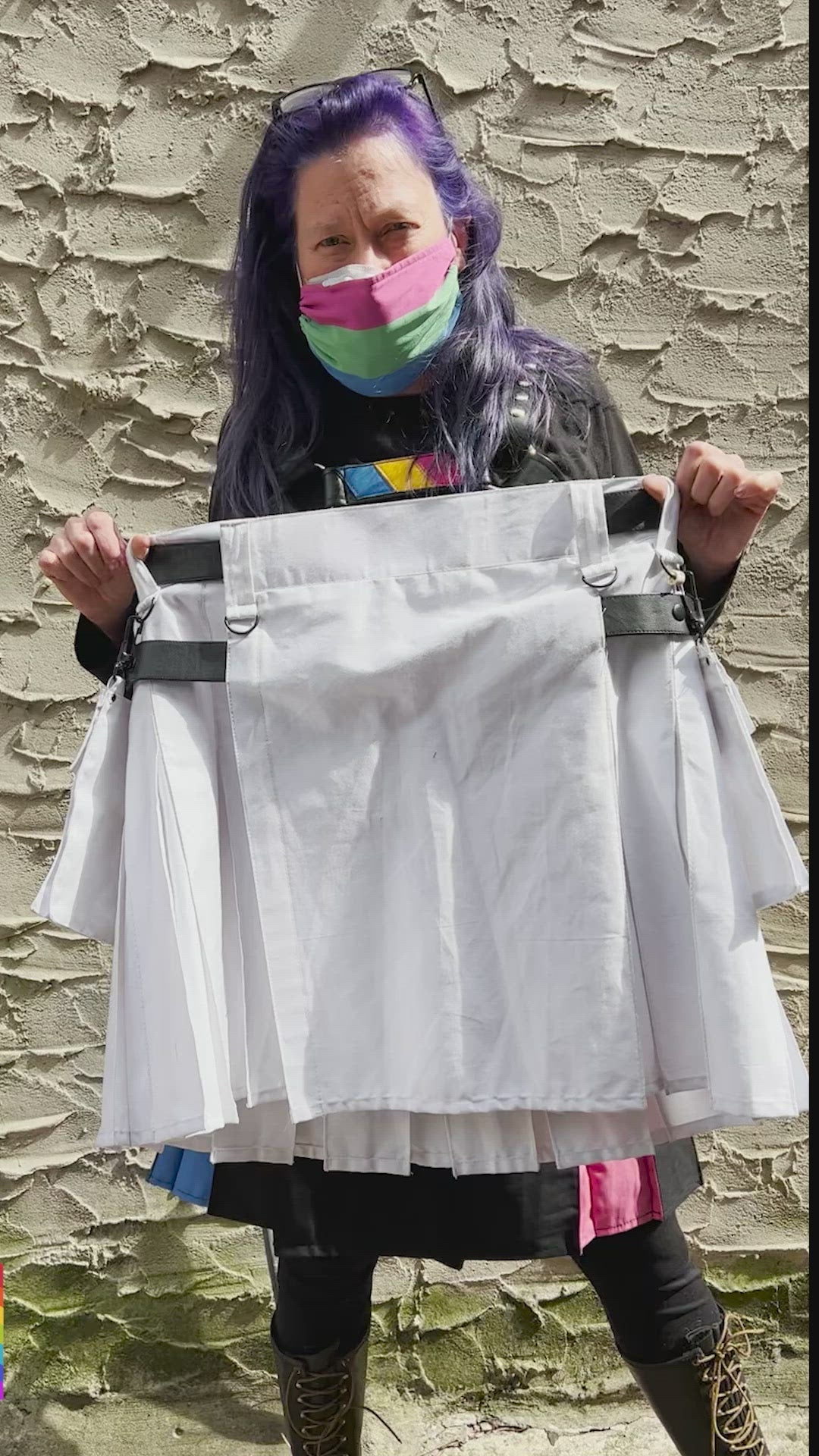 Model holding white heritage kilt swinging it back and forth.