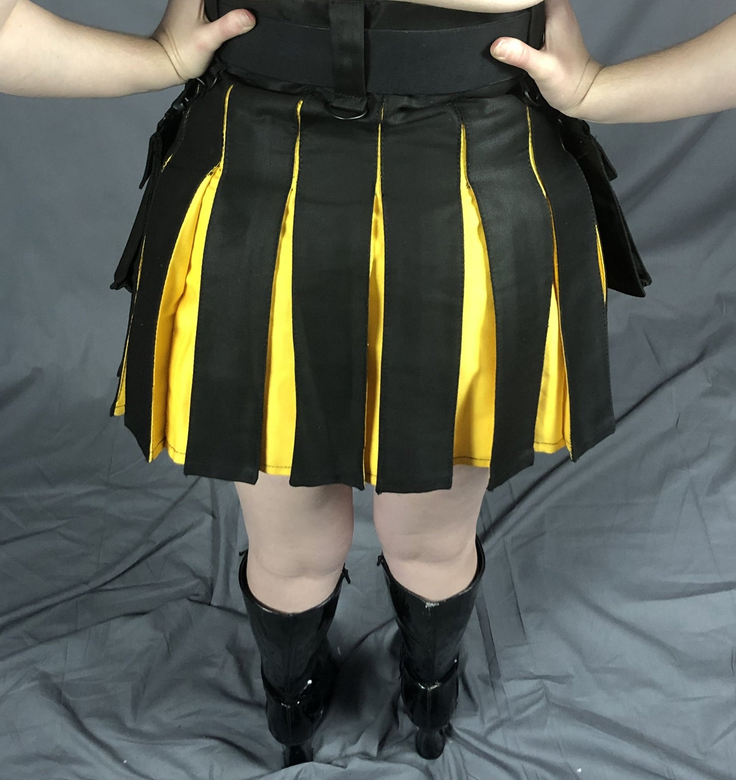 Black and yellow Mini Contrast Pleat Heritage Kilt, back view.