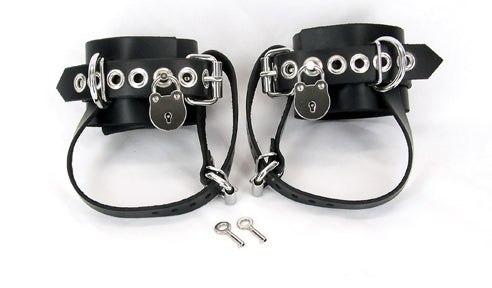 black shoe lock ankle cuffs, and keys against white background