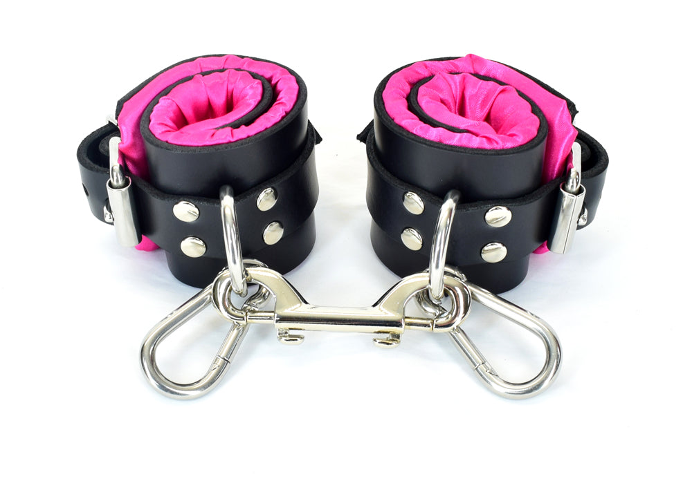 Black with Pink satin lined bondage cuffs with tentacle eyelets, locks on each cuff and keys.