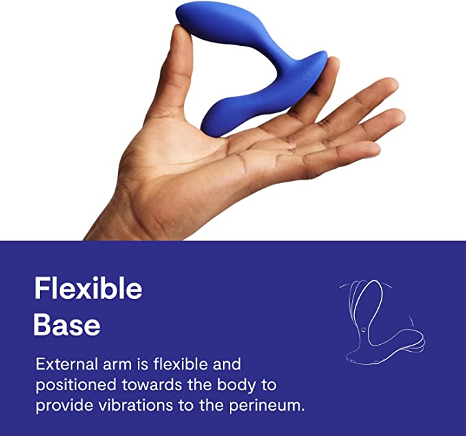 A hand holding the royal blue We-Vibe Vector+ Prostate Stimulator showing that it is flexible.