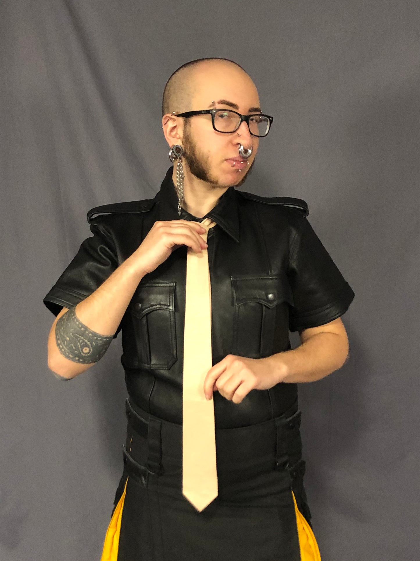 Beige leather necktie.
