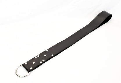 The plain black big leather slapper strap laid straight out, against white background.