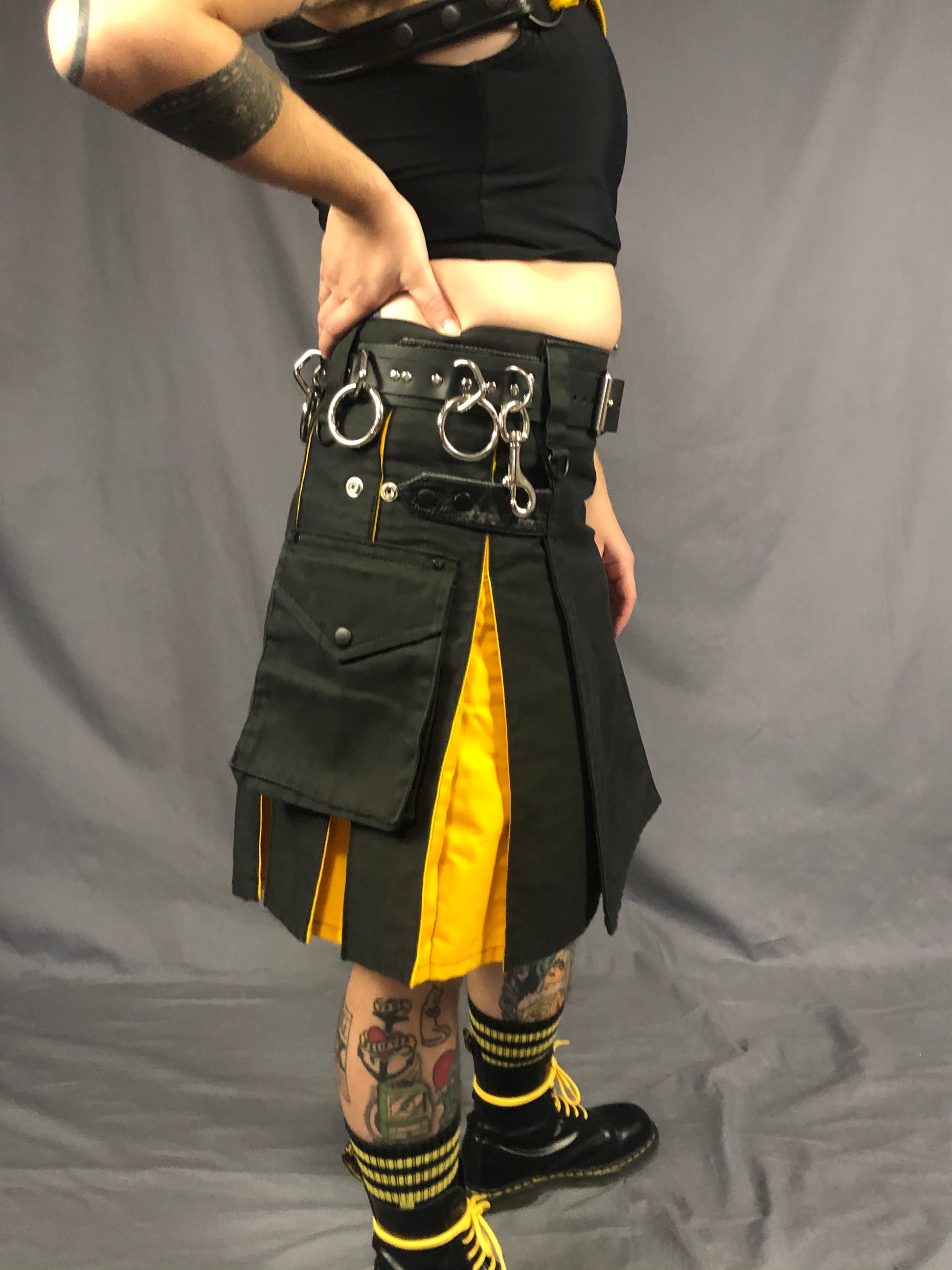right side close up of strapped bondage belt worn with kilt