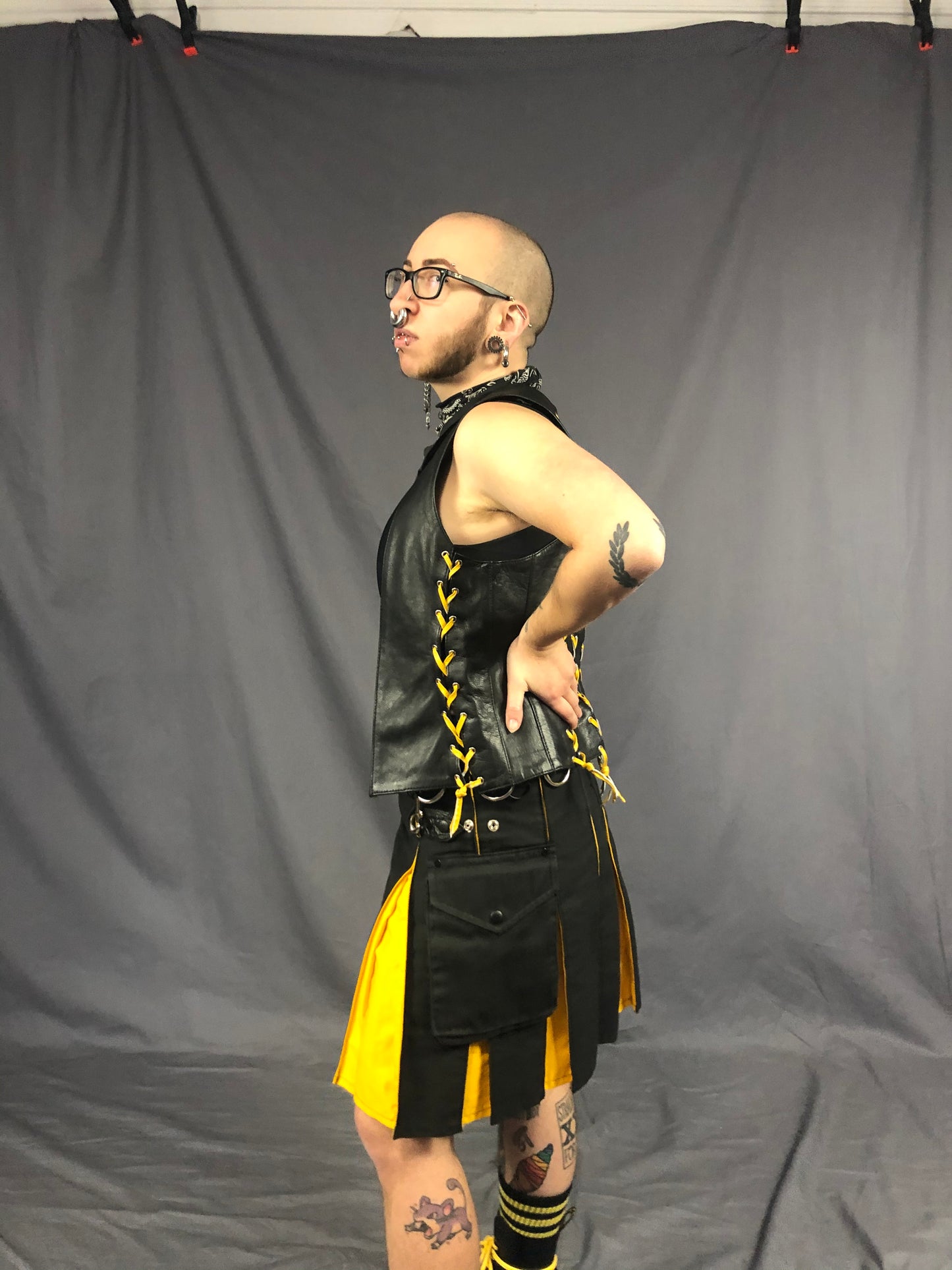 Left side view of black/yellow contrast pleat cargo kilt