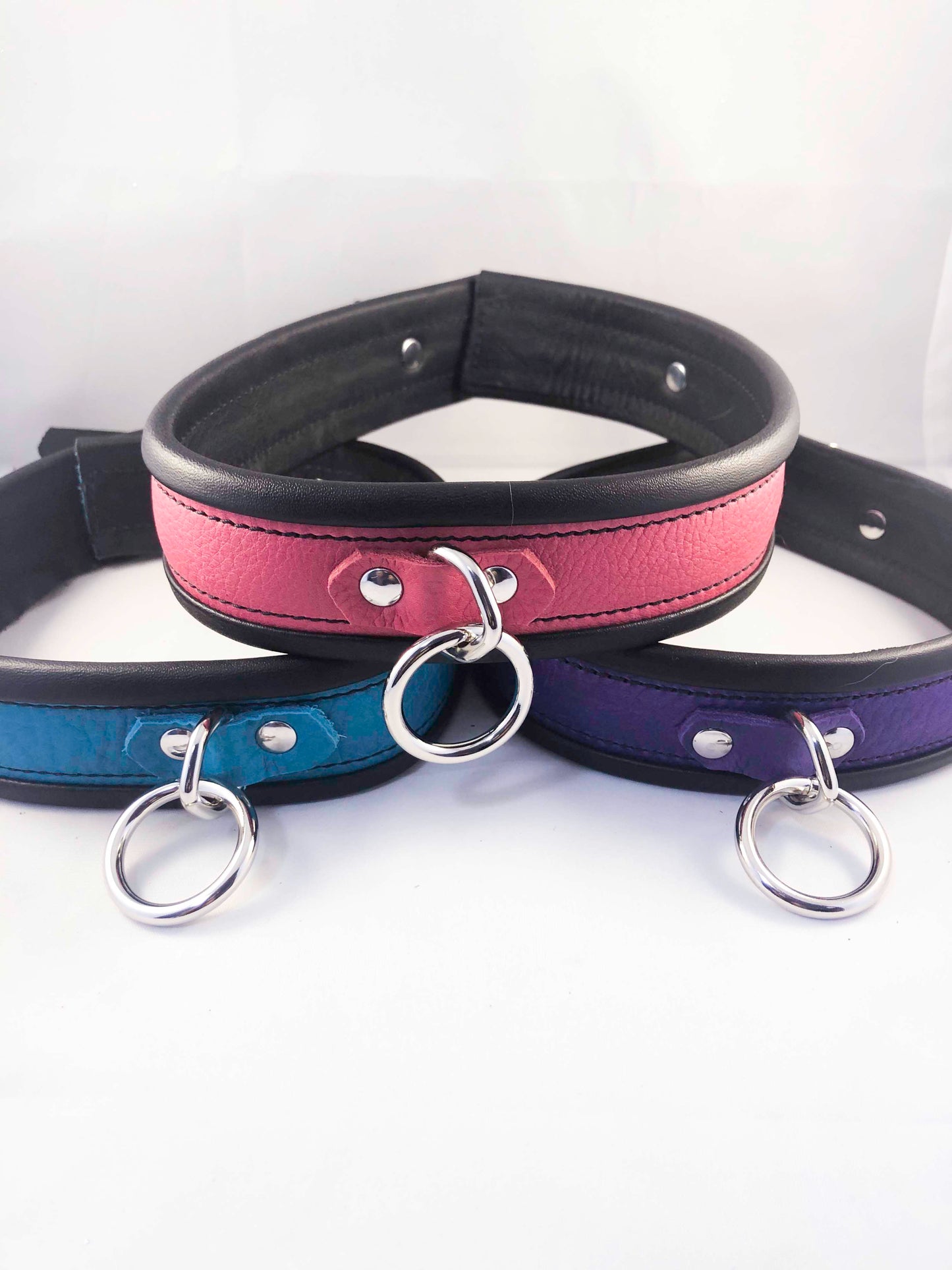 A trio of collars stacked in a pyramid configuration.