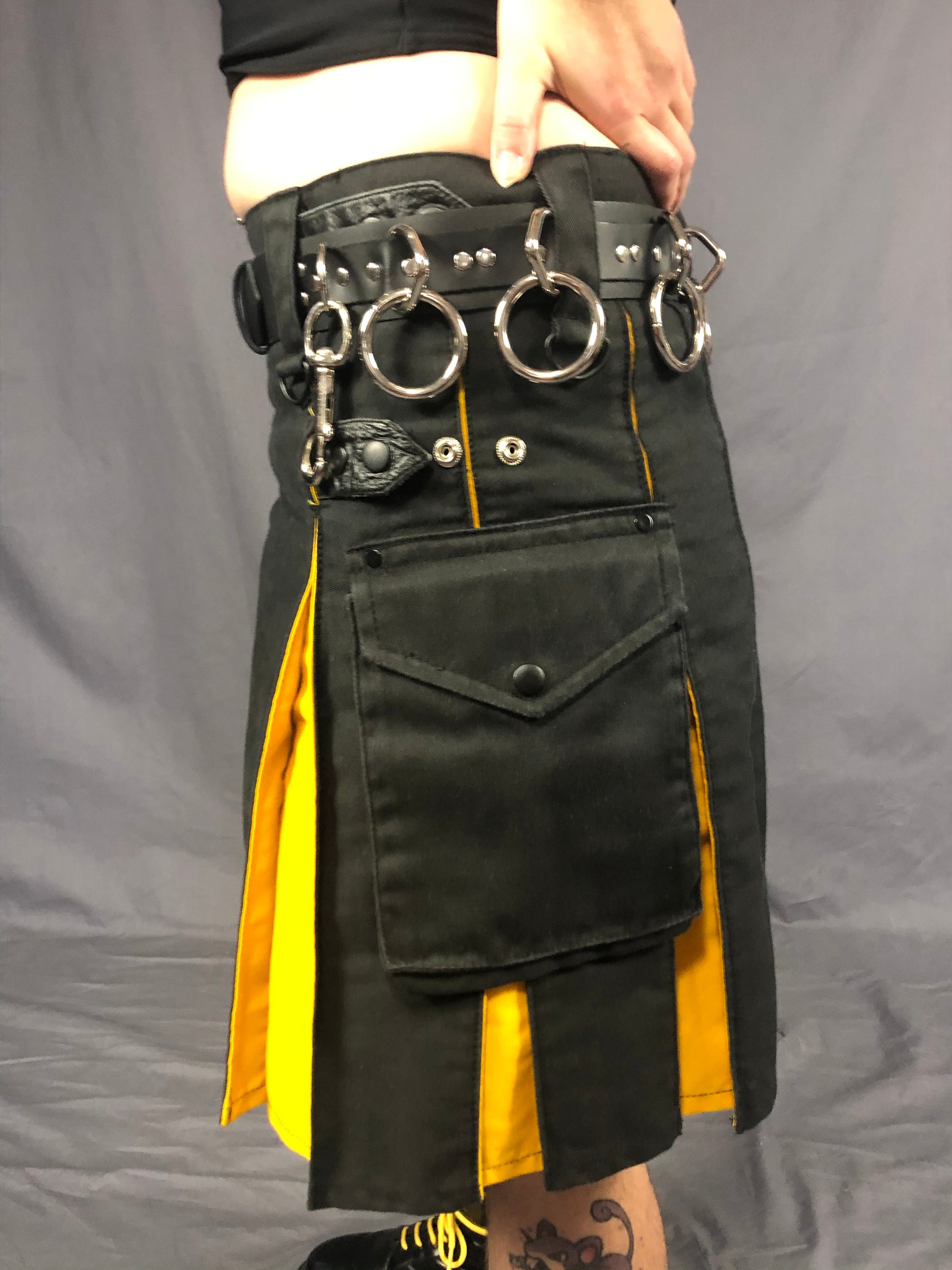 left side close up of strapped bondage belt worn with kilt