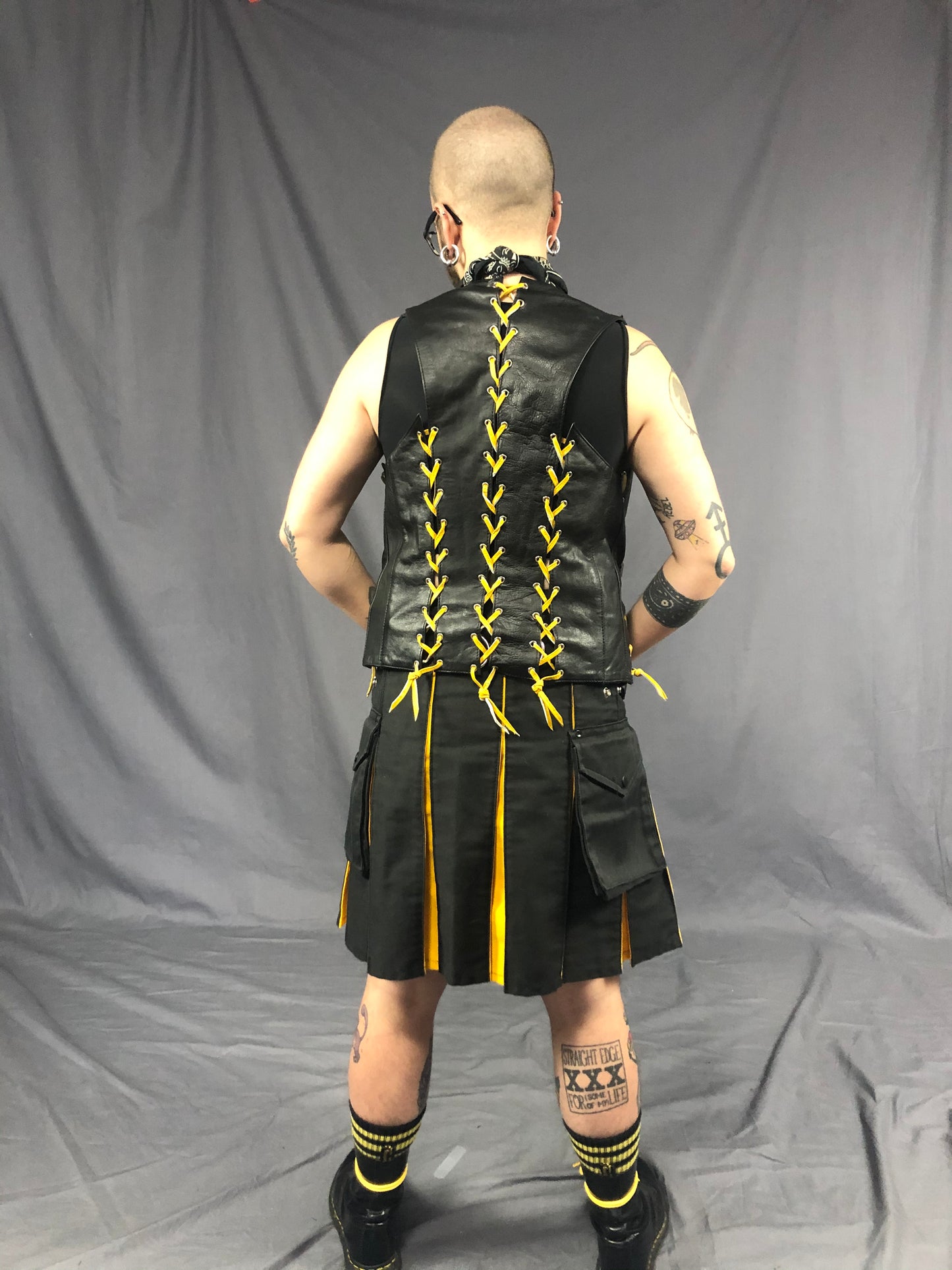 Back view of black/yellow contrast pleat cargo kilt