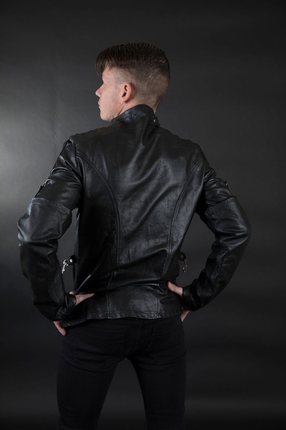 A model displaying the back of the Cowhide Strait / Jacket.
