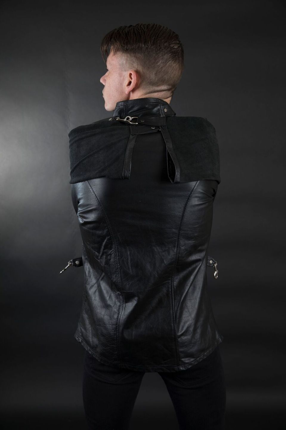 A model displaying the back of the Cowhide Strait / Jacket.