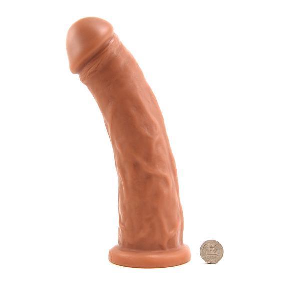 The Caramel Gambler Dildo next to a quarter for size reference.