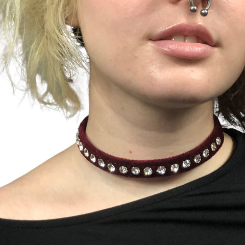 Model wears a eggplant velvet choker with clear rhinestones.