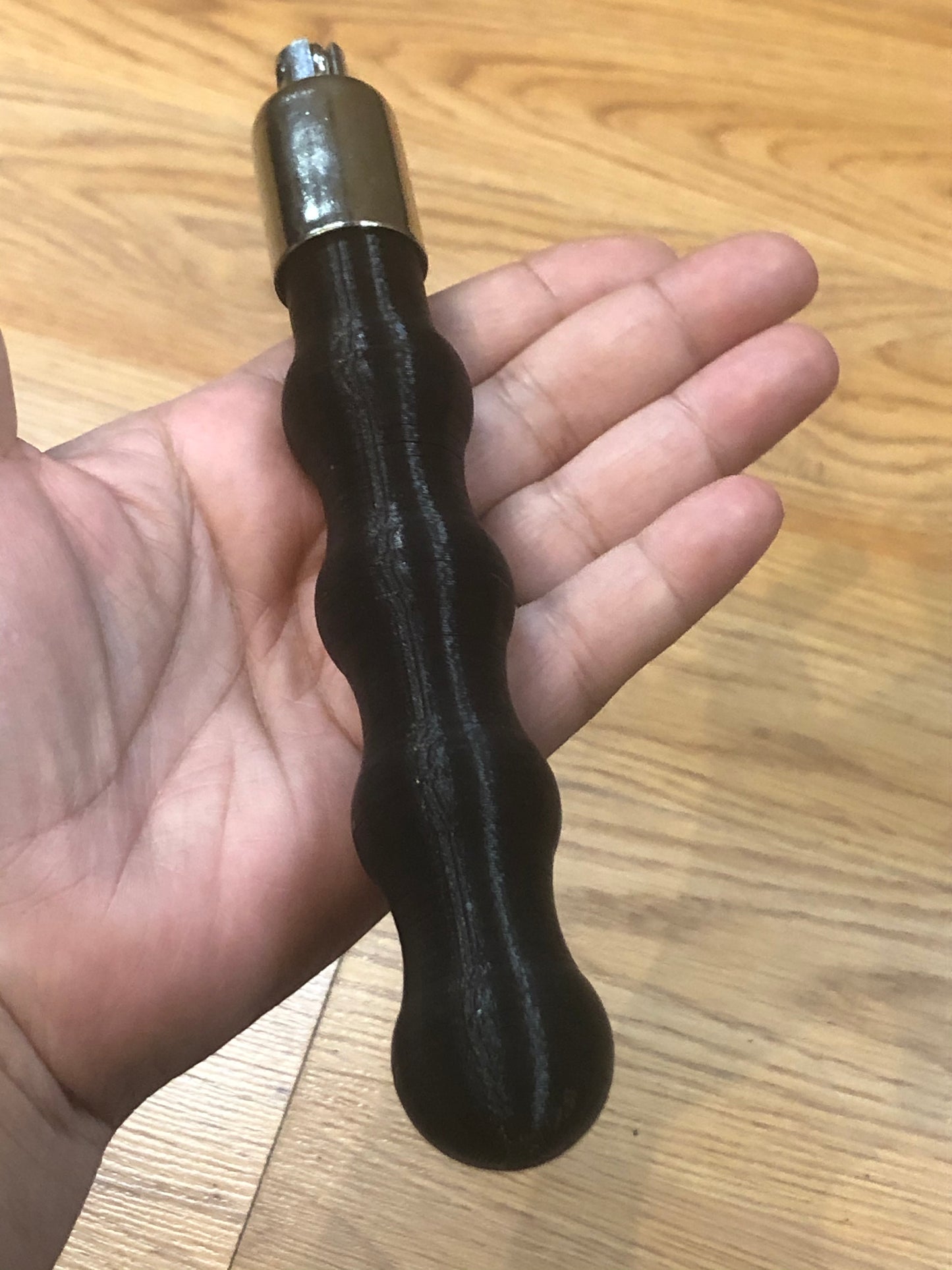 A hand holding the Flogger Handle.
