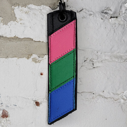 Polysexual Pride Flag Keyring Against a Wall