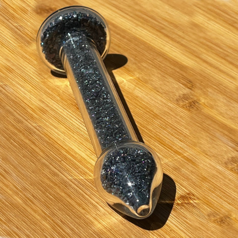 Goldstone crystal healing stone basix delight dildo on a bamboo board.