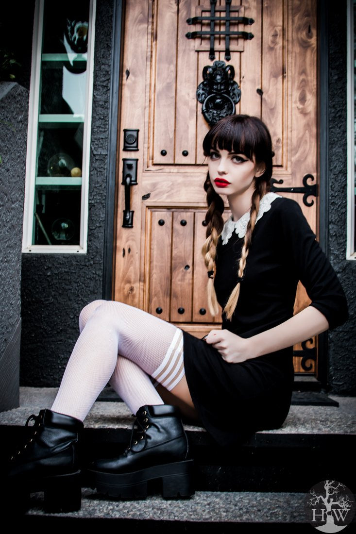 Sammy White Fishnet Thigh Highs on seated model, left side view,