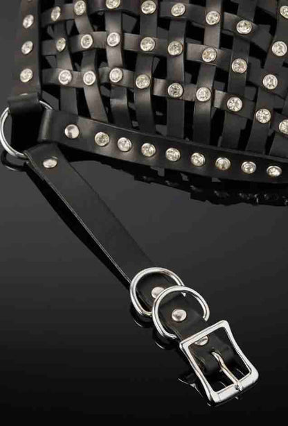A closeup of an O-ring, rivets and straps along with the buckle and strap closure of the Opulanta Obscura Luxury Leather Strapped Mask.