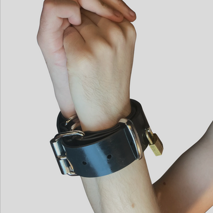 The Rubber Bondage Trick Belt around a person's wrists.