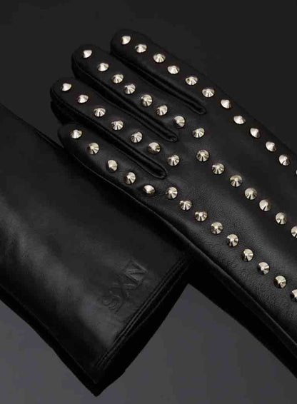 The outside of the Spiked Leather Forearm Glove lying flat on a black surface.