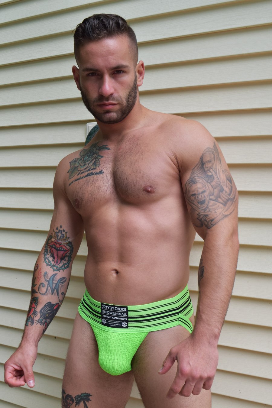 A model wearing the neon green CumDump Jockstrap.