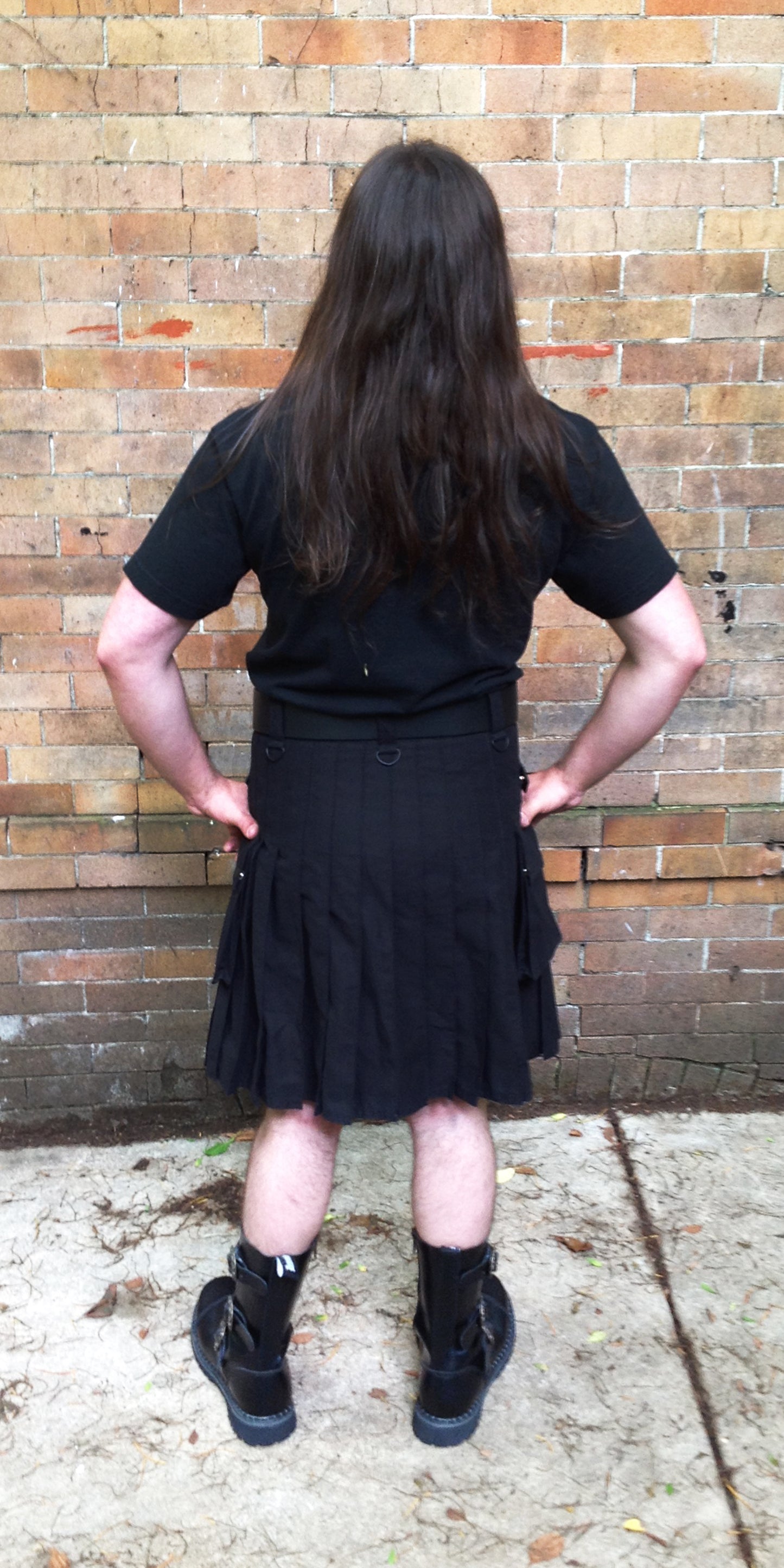 Model displaying the back of the black Cargo Kilt.