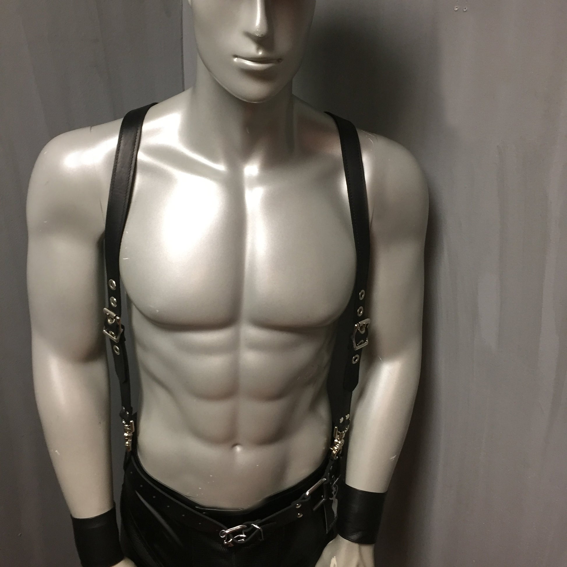 Front view of the Suspenders on mannequin wearing leather pants and leather armbands.