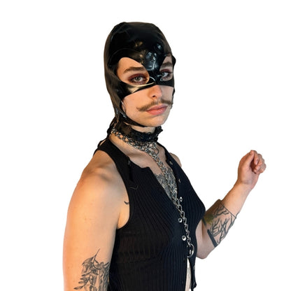 A model wearing black open mouth and eye basic latex hood, front view.