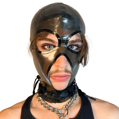 A model wearing translucent grey open mouth and eye basic latex hood, front view.