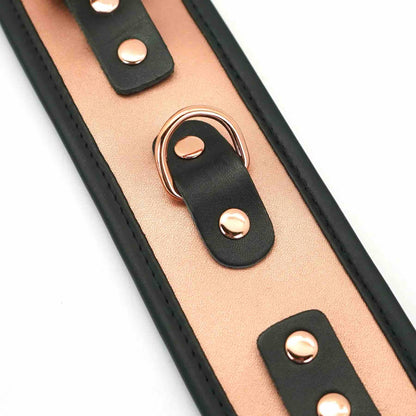 A close up of the D-ring on the Rose Gold Memory Leather Cuffs with Faux Fur LIning.